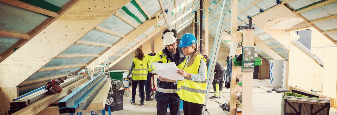 construction crew in building looking at paperwork